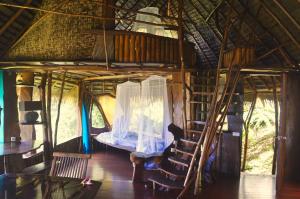 Teahupoo瓦尼拉旅舍的一间房子里带双层床和梯子的房间