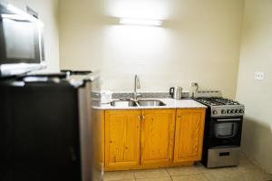 圣约翰斯康妮舒适套房酒店的厨房配有水槽和炉灶