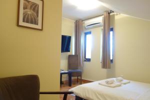 贝尔格莱德Villa Quantum Beograd的客房设有床、椅子和窗户。