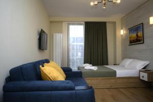 古多里New Gudauri, Red Co, Loft 1的酒店客房,配有床和蓝色的沙发