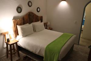 莱瓦镇Casa Hotel Santa Helena Boutique的一间卧室配有一张带绿毯的大床