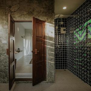 尖竹汶Baan Lek Villa的浴室设有木门和黑色瓷砖