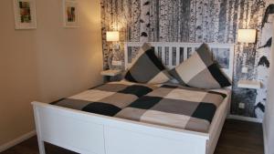 NeunkirchenFerienwohnung Seestern的一间卧室配有一张带黑白枕头的床