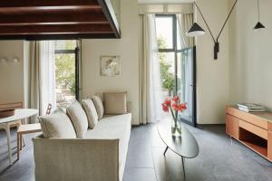 贝拉吉奥贝维德雷酒店的客厅配有白色的沙发和桌子