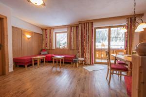 施图拜河谷新施蒂夫特维塔尔艾鹏酒店的客厅配有红色的沙发和桌子