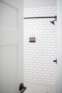 雷德蒙德SCP Redmond Hotel的浴室设有白色瓷砖淋浴间和2个卫生间