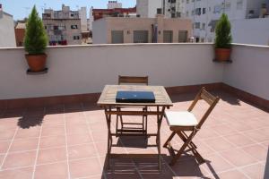 马略卡岛帕尔马君悦公寓 - 仅成年人的屋顶上的一张桌子和两把椅子