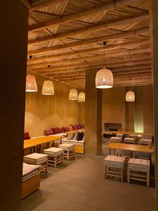 瓦尔扎扎特Kasbah Tamsna的餐厅设有桌椅和吊灯。