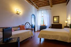 萨尔泰阿诺Albergo Santa Chiara的一间酒店客房,设有两张床和电视