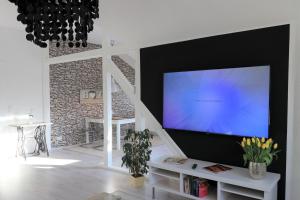 鲁尔河畔米尔海姆Ferienwohnung Villa Ruhr的客厅配有壁挂式大屏幕平面电视