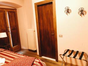 多莫多索拉皮埃蒙特斯奥拉宾馆的一间卧室配有一张床和一扇木门