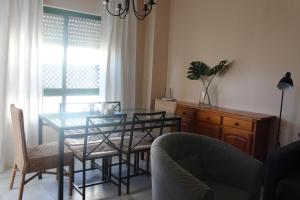 圣玛丽亚港Apartamento El Ancla - cerca la playa的一间设有玻璃桌和椅子的用餐室