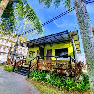 珍南海滩卡萨菲娜美好家园的黄色的房子,有门廊和棕榈树