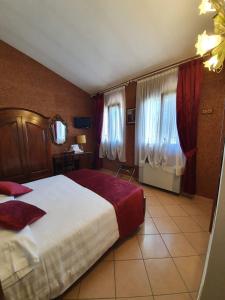 法瓦罗威尼托Agriturismo Eva的一间酒店客房,配有大床和窗帘