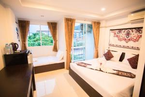 芭东海滩Happy 99 Guest house的小房间设有床和窗户