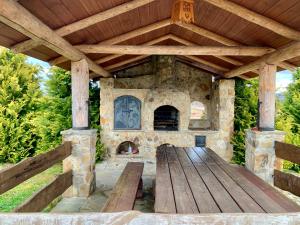 伊斯泰布纳Domek na górze -Odetchnij od miasta w Istebnej的户外庭院设有石制壁炉和木桌。