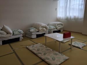 富士吉田市街のホテル的客房设有两张沙发、一张桌子和一张沙发。
