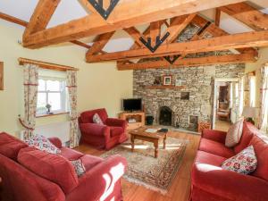 KilkellyCluaincarraig的客厅设有红色的沙发和石制壁炉
