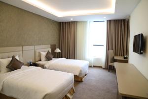 孟青大清化酒店客房内的一张或多张床位