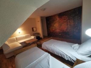 奥托查茨贾斯卡酒店的酒店客房设有两张床,墙上挂有绘画作品