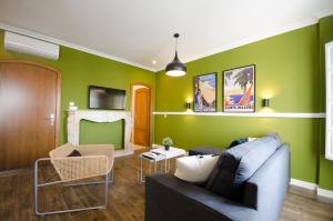 梅里达Apartamentos Suites Roma的客厅设有绿色的墙壁和沙发