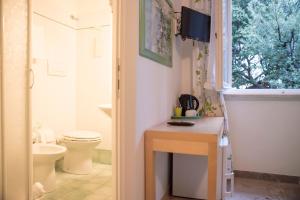 圣温琴佐La Zattera Camere的一间带卫生间、水槽和窗户的浴室