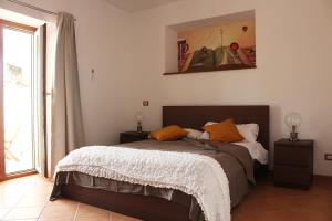 内皮Il Granaio Del Pavone的一间卧室配有带橙色枕头的床