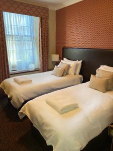 阿伯丁The Globe Inn的配有窗户的酒店客房内的两张床