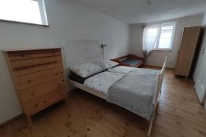 班斯卡-比斯特里察Ubytovanie v Banskej Bystrici - dom s terasou的一间卧室配有床、梳妆台和窗户。