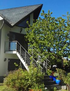 开姆尼茨Wildes Paradies,135 qm Ferienwohnung im Naturgarten的一座房子,设有通往门廊的楼梯