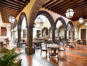 特基拉索拉德拉斯马斯酒店的餐厅设有拱门和桌椅