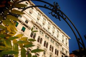 米兰Hotel Principe Di Savoia - Dorchester Collection的前面有栅栏的高大的白色建筑