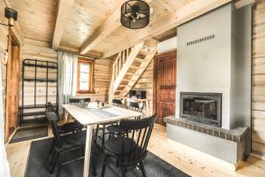斯伽尔达Kalnziedi的小木屋内带壁炉的用餐室