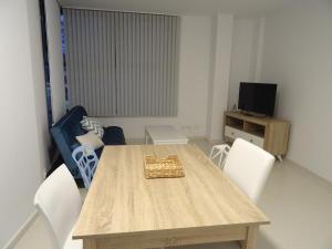 卡拉塔尤德Apartamento Plaza San benito 4的一间带木桌和白色椅子的用餐室