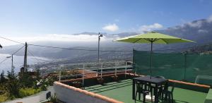蓬塔利亚纳Vistas para el relax的一个带桌子和遮阳伞的网球场