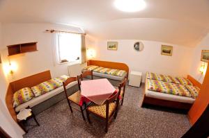 弗尔赫拉比Pension 444 - Ski Resort Herlikovice and Bubakov的小房间设有两张床和一张桌子