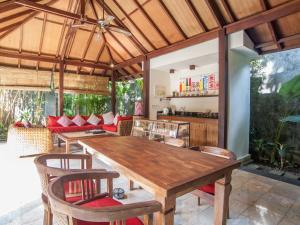 金巴兰芒果树别墅的一间带木桌和椅子的用餐室