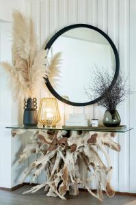 邓斯伯勒帝国温泉休闲酒店的一张带镜子和羽毛的台面