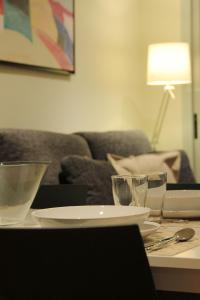 巴塞罗那阿尔格拉工业酒店式公寓的一张桌子,上面有盘子和玻璃杯,上面有沙发