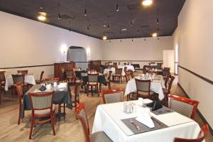 夏洛特阿马利亚温沃尔德帕萨奇酒店的一间设有白色桌椅的用餐室和一间设有