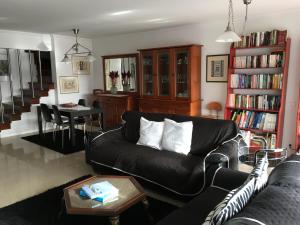 里斯本Home2Home Lisbon的客厅配有黑色沙发和桌子