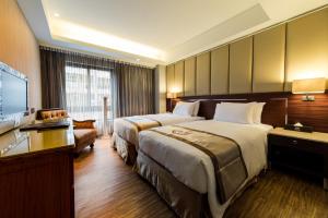 台北豪城商旅民生馆的酒店客房设有两张床和一台平面电视。