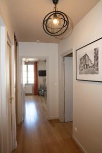 图尔尼Appartement A-Mi-Chemin - Centre-ville de Tournus的一间走廊上的房间,墙上挂着一幅画
