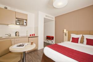 楠泰尔楠泰尔拉德芳斯酒店的酒店客房带一张床和一个厨房