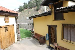 坎加斯德尔纳尔塞亚La Puchera的一座带长凳的建筑,毗邻一座带山丘的建筑