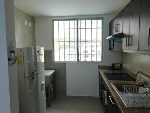 通苏帕Dpto Moderno Frente al Mar. Edf: Deymar 7mo Piso的厨房配有白色冰箱和窗户。