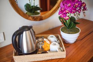 乌布Bisma Terrace Suite Ubud的茶壶和鲜花的桌子