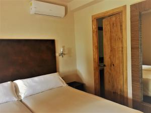 塔里法特里斯马里斯休闲酒店的一间卧室配有一张床和一扇木门