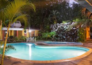 雷塔卢莱乌罗斯奎乔斯豪宅酒店的后院的游泳池,带有岩石墙