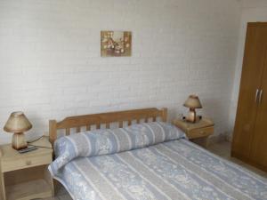 Alquileres Piriapolis客房内的一张或多张床位